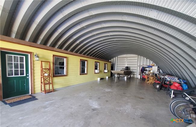 Apartment and view to rear door (center) shows depth & height of the unit for storage capabilities! | Image 6