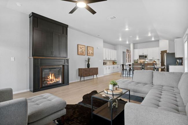 The fireplace creates contrast in the bright and airy home. | Image 17