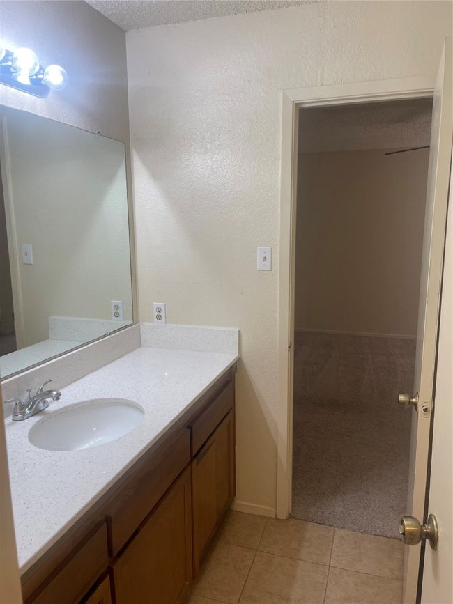 Bathroom featuring vanity and tile patterned flooring | Image 11