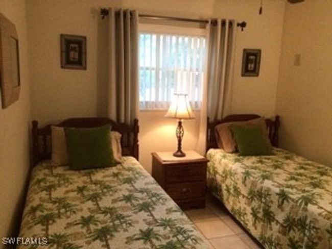 Bedroom with light tile patterned floors | Image 17