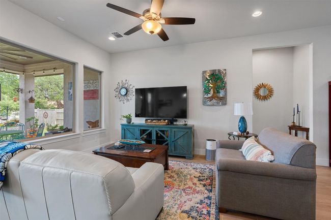 Living area featuring wood finished floors, ceiling fan, baseboards, and recessed lighting | Image 9