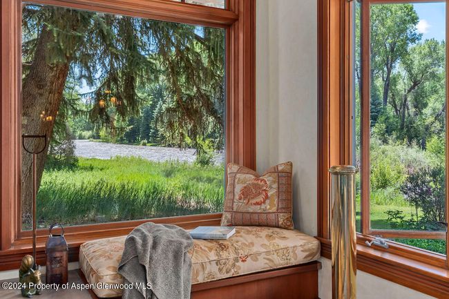 A wonderful window seat with views up the Roaring Fork River invites reading and napping here all day. Early morning sunshine. | Image 10