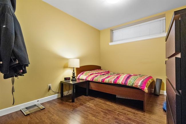 Bedroom with wood finished floors and baseboards | Image 30