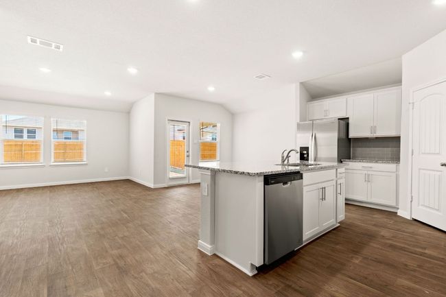 Kitchen island with stainless steel finishes, recessed lighting, and vaulted ceiling | Image 4