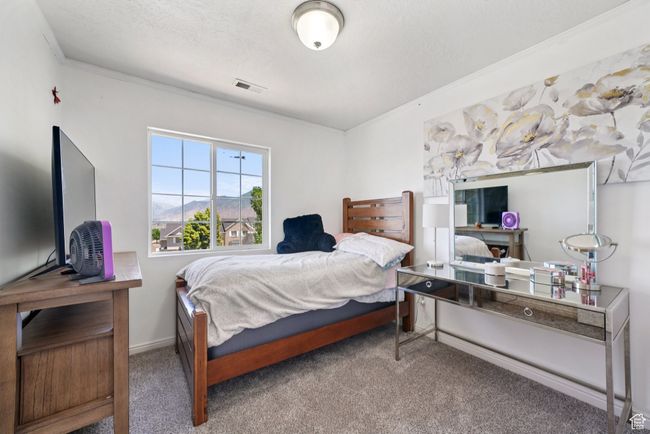 Bedroom featuring carpet, ornamental molding, and an office area | Image 12