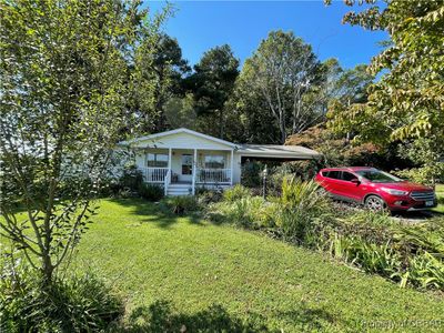 View of front facade with a front yard and covered porch | Image 2