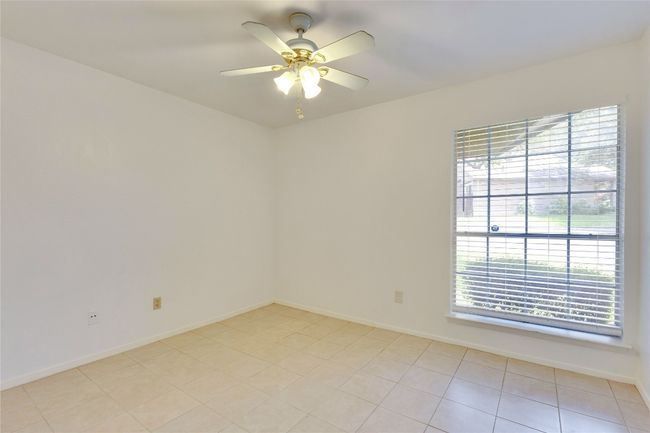 Unfurnished room with healthy amount of natural light and a ceiling fan | Image 17