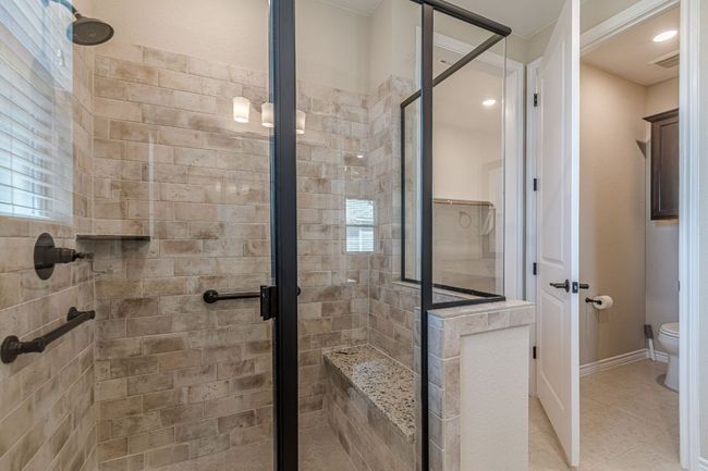 Bathroom with a stall shower, tile patterned flooring, and plenty of natural light | Image 28
