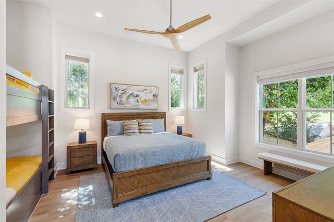 Bedroom 2 featuring multiple windows, light wood-style flooring, recessed lighting, and ceiling fan. | Image 26