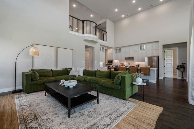 Large open living area and beautiful iron banister overlooking from the upstairs loft. | Image 5