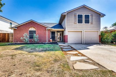 View of front property featuring a front yard and a garage | Image 1