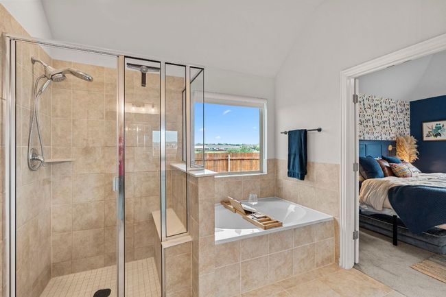 Ensuite bathroom with vaulted ceiling, a stall shower, a garden tub, and tile patterned flooring | Image 23