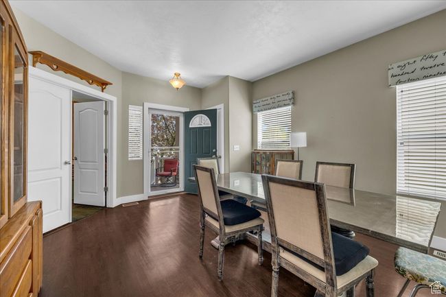 Dining room featuring baseboards and dark wood-type flooring | Image 6