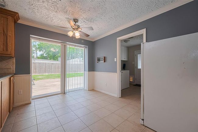 Breakfast room is spacious and features a ceiling fan and a wonderful view to the backyard. The laundry room and half bathroom are located just to the right. | Image 7