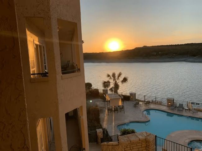 Community pool featuring a water view, a patio, and a hot tub | Image 16