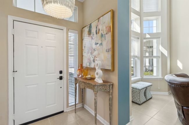 Step into a bright and airy entrance with soaring ceilings and natural light. | Image 26