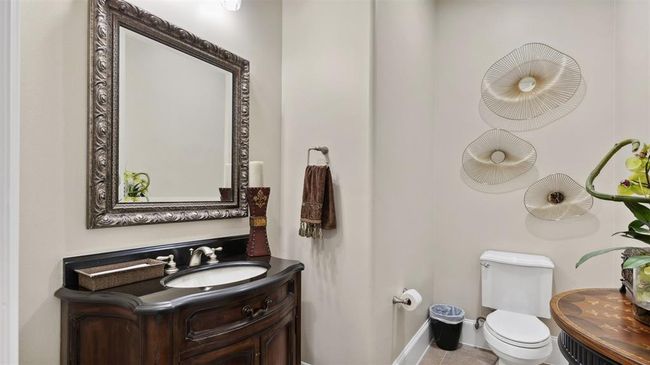Oversized powder bath on the main floor with a custom vanity and high ceilings will make you guests feel right at home. | Image 30