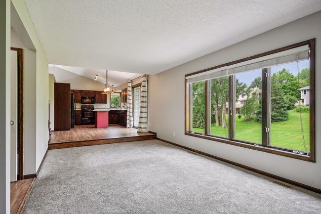 The family room has a wall of windows overlooking the backyard | Image 8