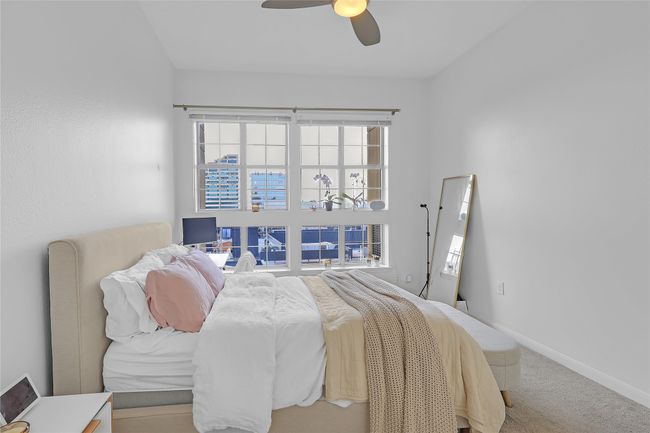 Carpeted bedroom featuring multiple windows and a ceiling fan | Image 15