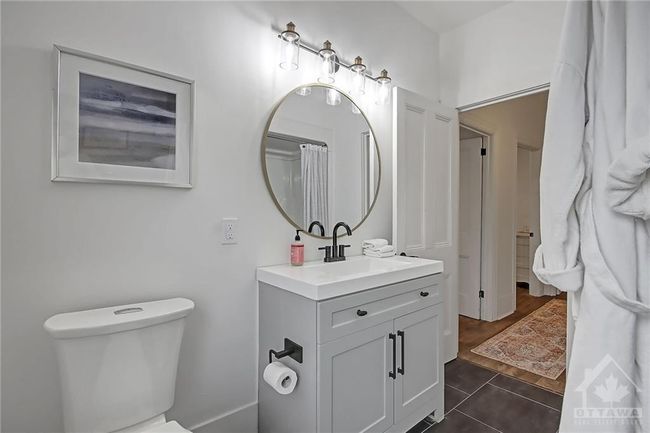 Family bathroom with new vanity, toilet, fixtures and stylish new light fixture | Image 20