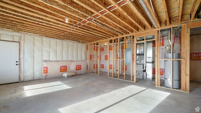 Unfinished basement with secured water heater and heating unit | Image 25