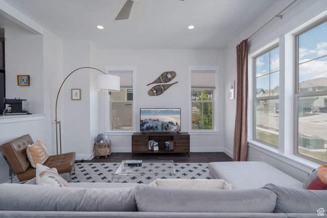 Living area with wood finished floors, ceiling fan, baseboards, and recessed lighting | Image 6
