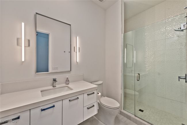 Full bathroom featuring vanity, a stall shower, and toilet | Image 12