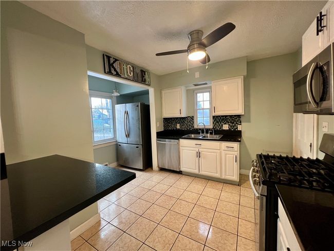 Kitchen with white cabinets and stainless steel appliances | Image 5
