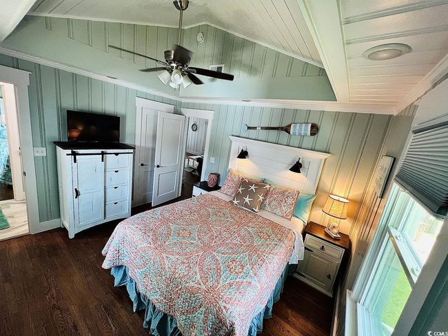 Bedroom with vaulted ceiling, dark hardwood / wood-style floors, ceiling fan, and ornamental molding | Image 14
