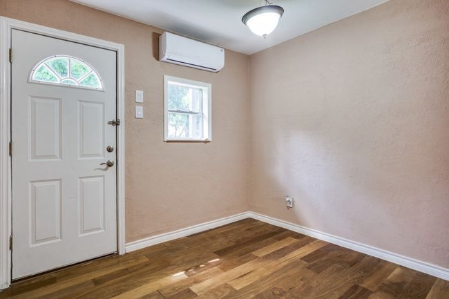 Foyer featuring a wall unit AC and dark wood-type flooring | Image 9