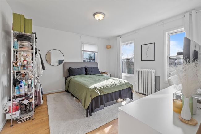 Bedroom featuring light hardwood / wood-style flooring and radiator | Image 8