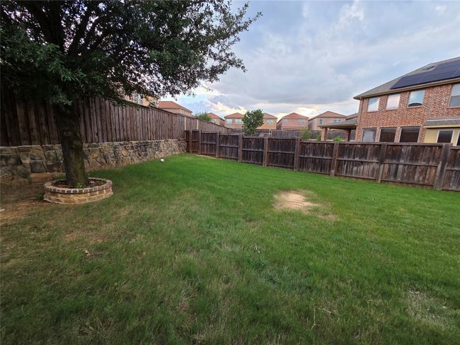 View of fenced backyard | Image 17