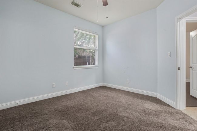 Unfurnished room with carpet, a ceiling fan, and baseboards | Image 23