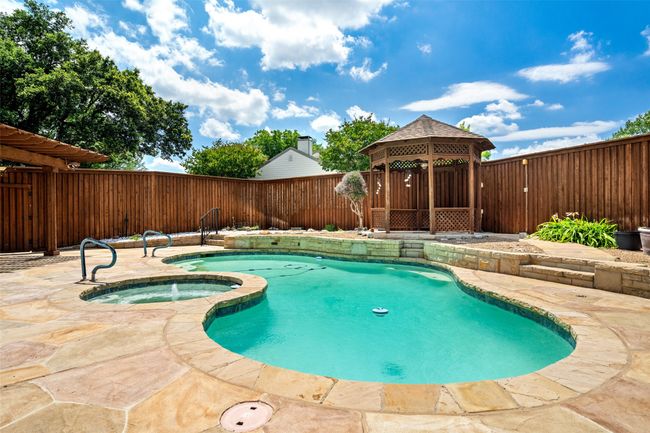 View of swimming pool with a gazebo, a fenced backyard, an in-ground hot tub, and a patio | Image 6