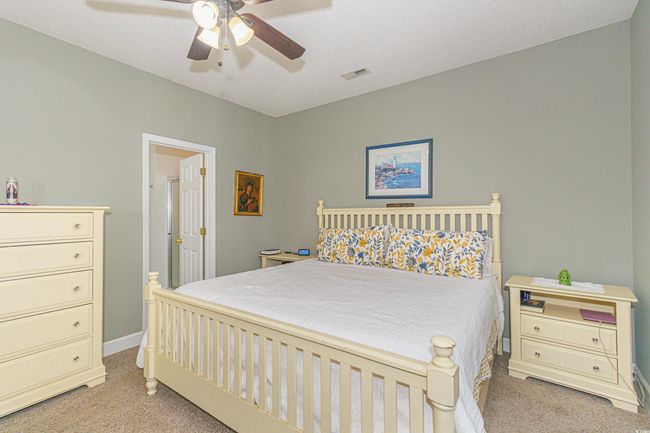 Bedroom featuring ceiling fan and light colored carpet | Image 15