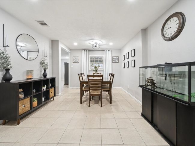 Dining space featuring light tile patterned floors, baseboards, and recessed lighting | Image 9