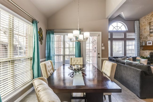 Dining space featuring lofted ceiling, a wealth of natural light, and an inviting chandelier | Image 15