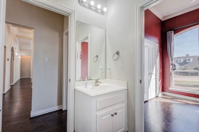 Bathroom featuring hardwood / wood-style flooring, vanity, and ornamental molding | Image 9