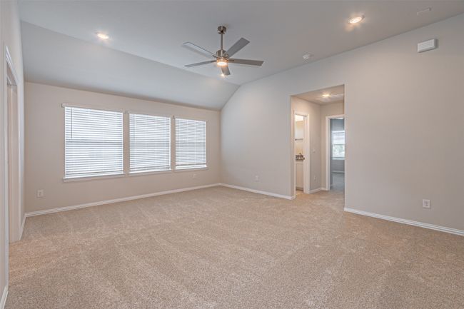 Spare room featuring light colored carpet, a ceiling fan, vaulted ceiling, and recessed lighting | Image 31