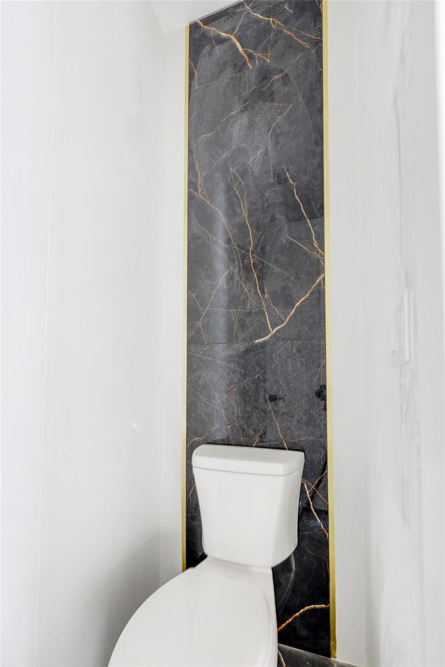 Bathroom with tile walls and toilet | Image 32