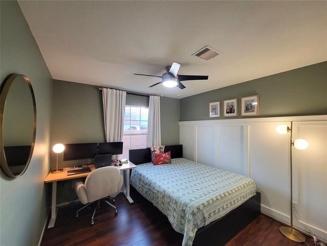 Spacious bedroom with wainscoting on one side and a large closet space. | Image 25