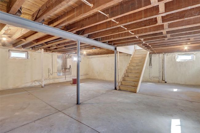 Basement featuring stairway and plenty of natural light | Image 25
