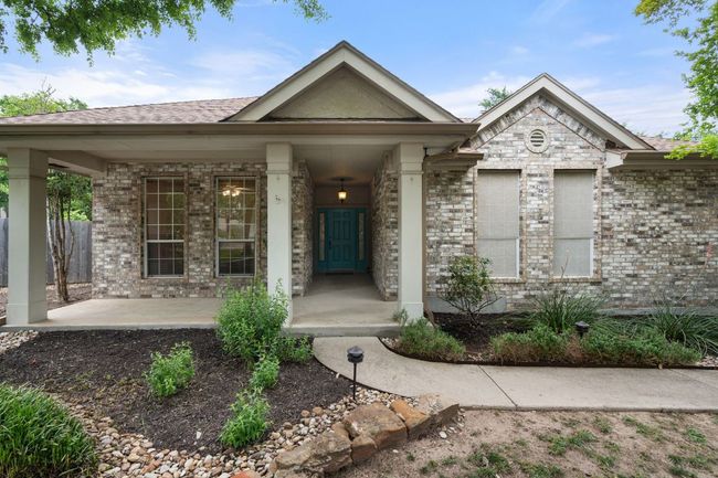 View of front of property with brick siding, fence, and a shingled roof | Image 4