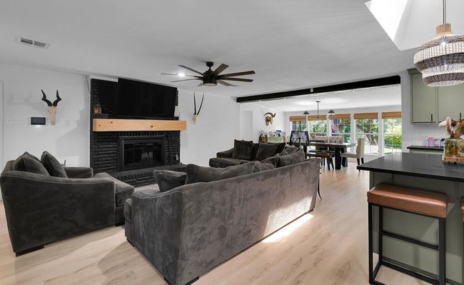 Living area featuring ceiling fan, light wood finished floors, and recessed lighting | Image 4