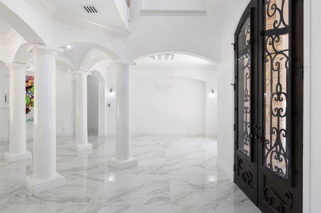 Entryway featuring marble tiled floors and crown molding | Image 6