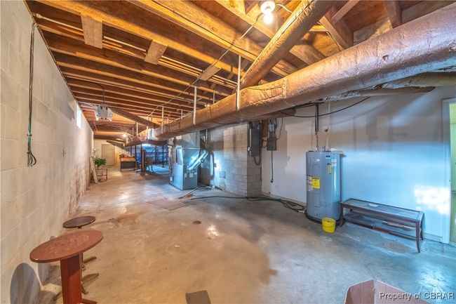 Basement with heating unit, electric panel, and electric water heater | Image 32