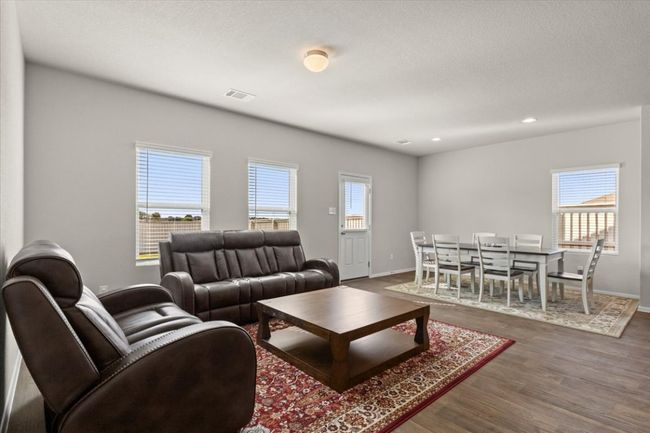 Living area with wood finished floors, healthy amount of natural light, baseboards, and recessed lighting | Image 8