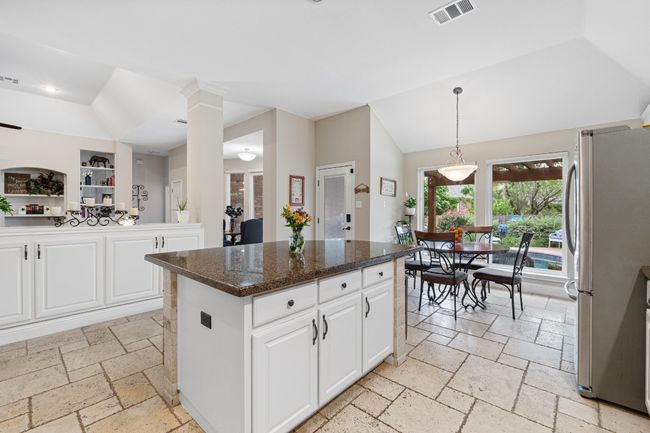 Open kitchen with stainless steel appliances, and view of pool | Image 14