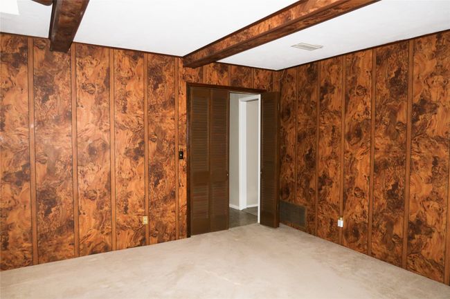 Empty room with beam ceiling and visible vents | Image 24