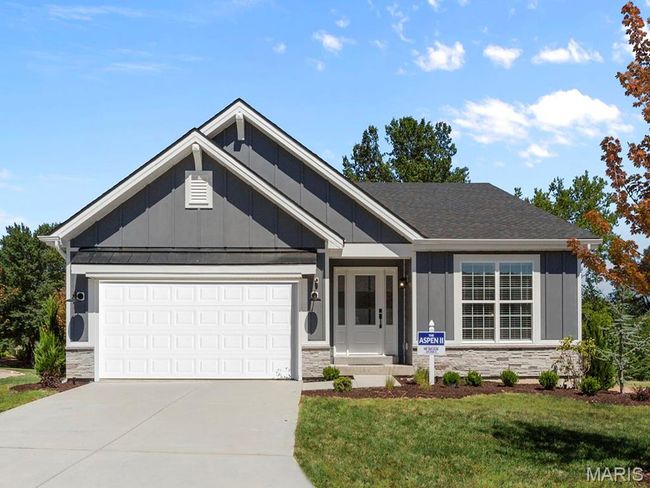 Single story home featuring board and batten siding, stone siding, driveway, an attached garage, and a front lawn | Image 5